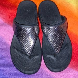Black crocs family flip-flops with metallic design